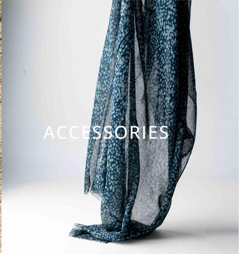 A patterned scarf hanging against a pale wall